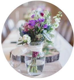 A flower arrangement on a set dining table